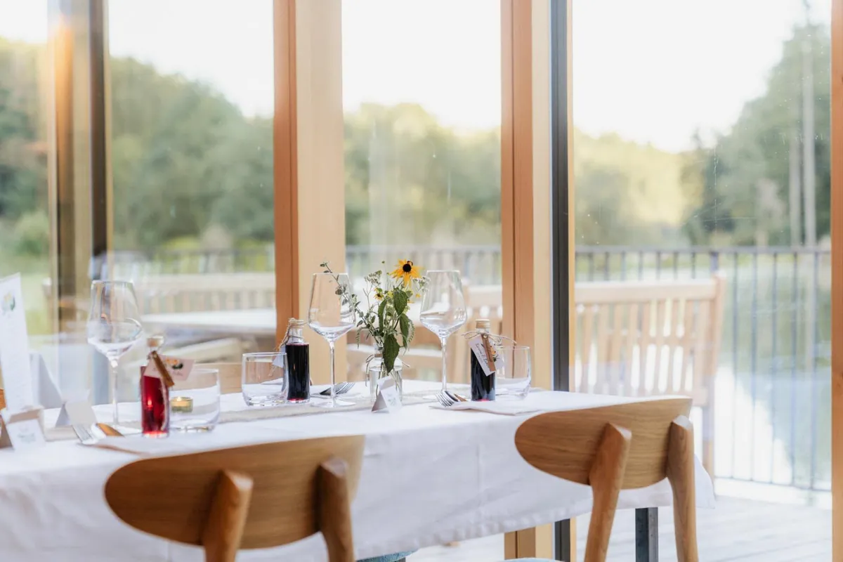 Romantisch gedeckter Tisch für zwei mit Wildblumen und Blick ins Grüne